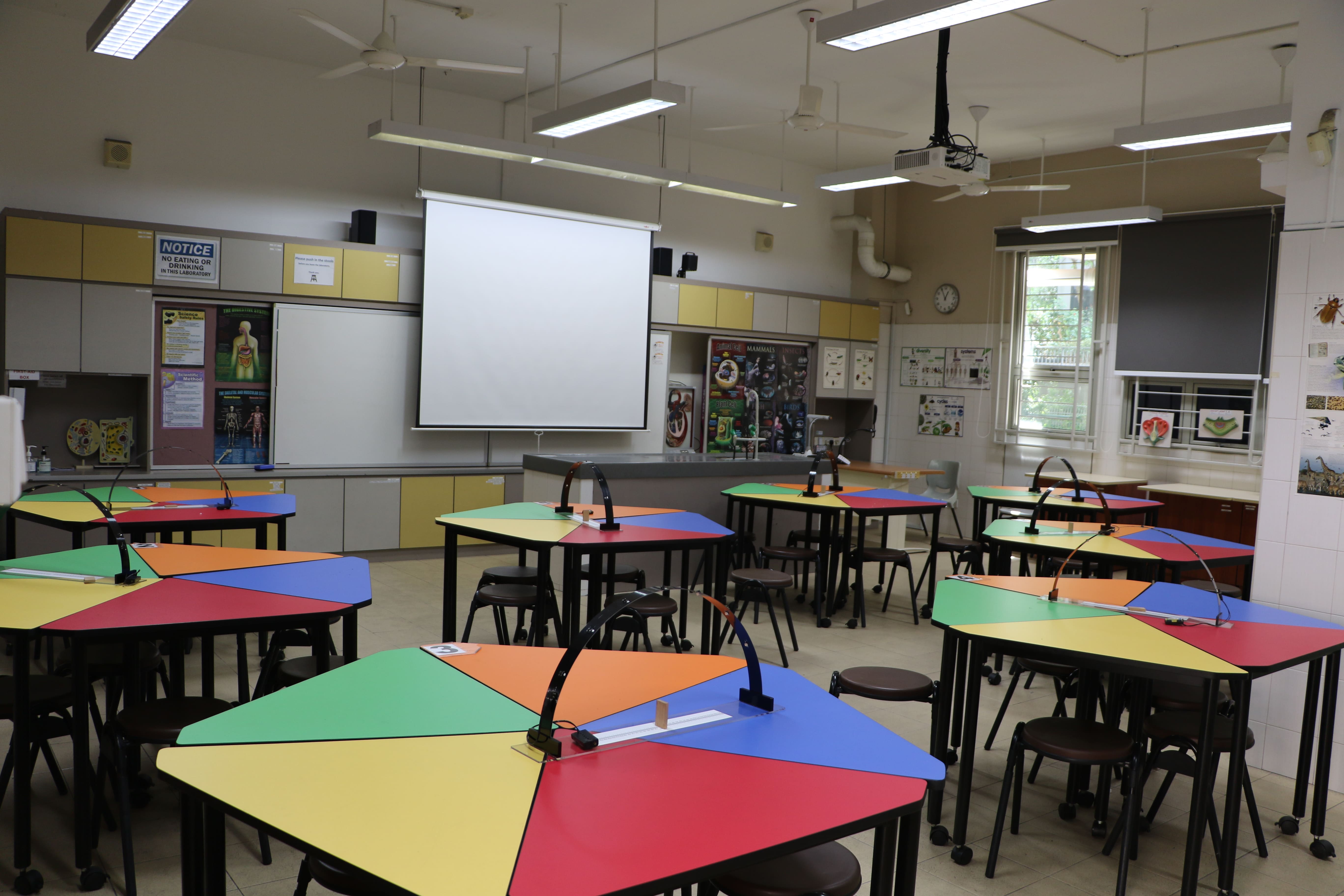 School science laboratory with colourful worktables and learning displays.